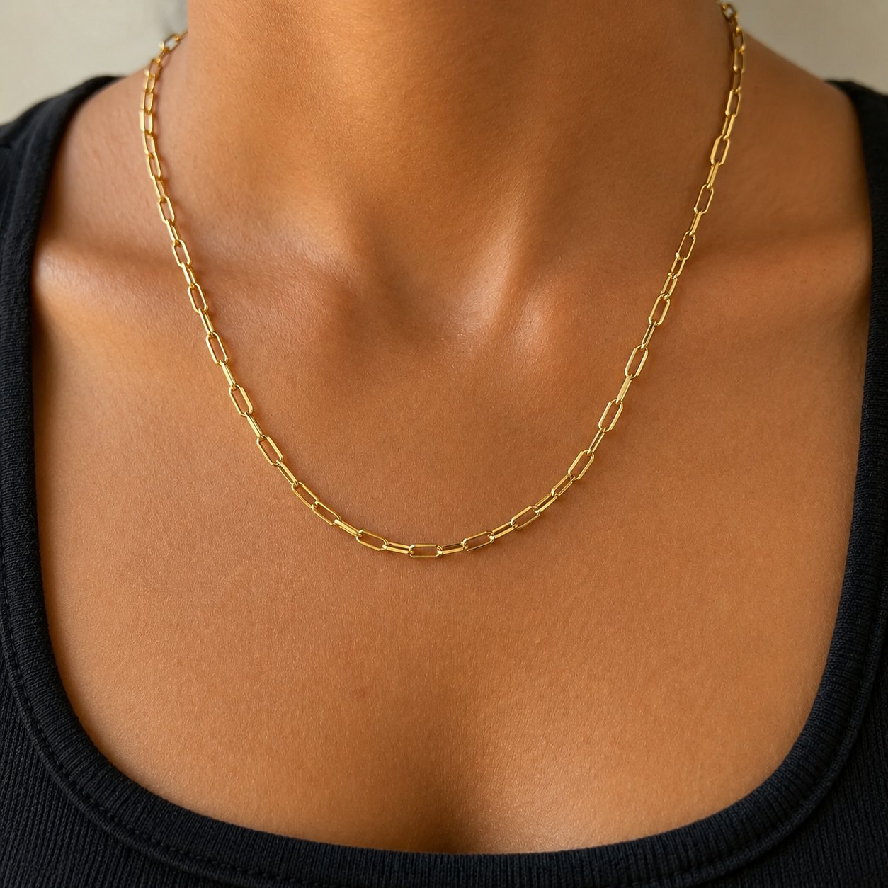 Close up of amara gold earrings and layered necklaces